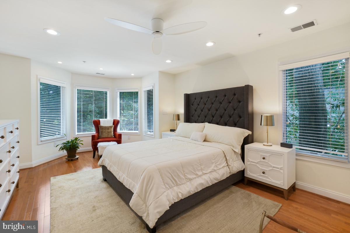 412 Silver Spring Avenue Silver Spring, MD 20910 - Photo 33 of 48 a bedroom with a large bed and wooden floor