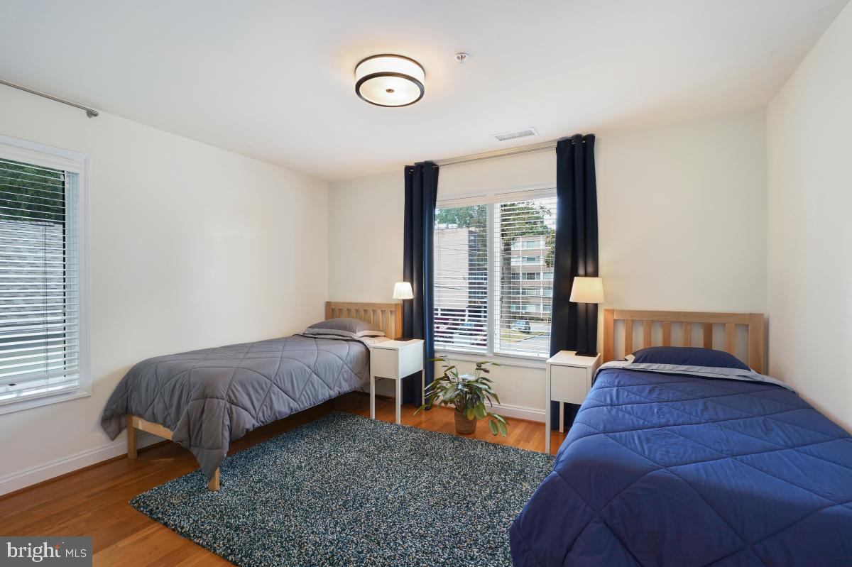 412 Silver Spring Avenue Silver Spring, MD 20910 - Photo 37 of 48 a bedroom with furniture and a large window