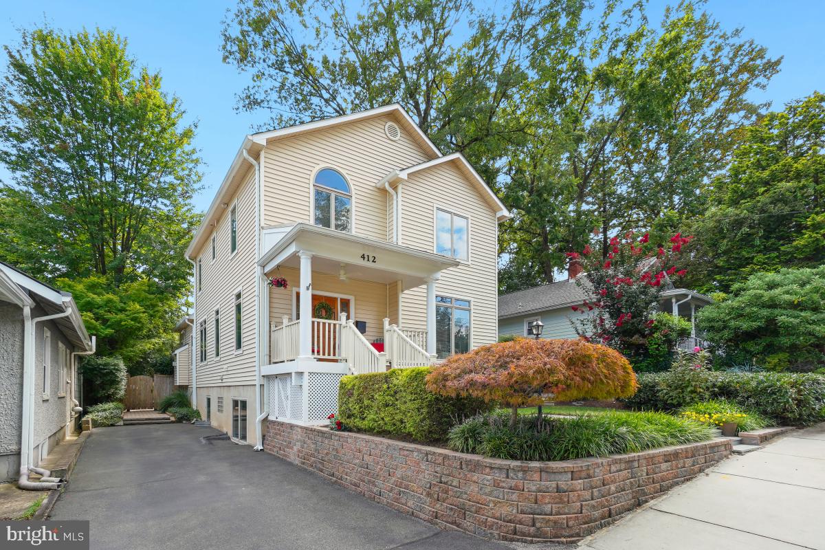 412 Silver Spring Avenue Silver Spring, MD 20910 - Photo 4 of 48 a view of a white house with a small yard and large tree