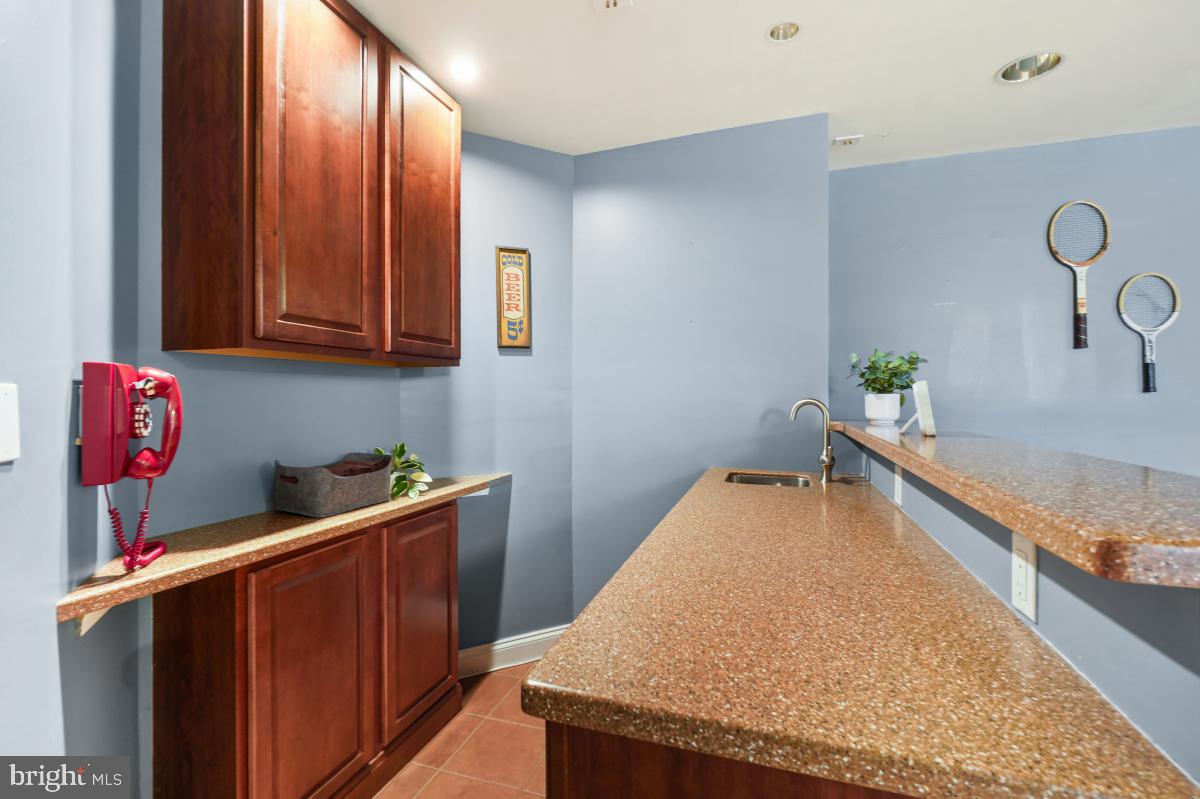 412 Silver Spring Avenue Silver Spring, MD 20910 - Photo 43 of 48 a kitchen with granite countertop cabinets and sink