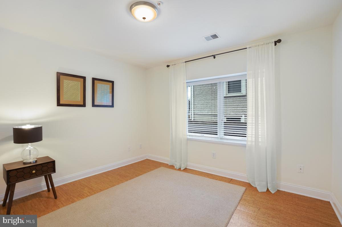 412 Silver Spring Avenue Silver Spring, MD 20910 - Photo 44 of 48 a bedroom with a bed and a table in it