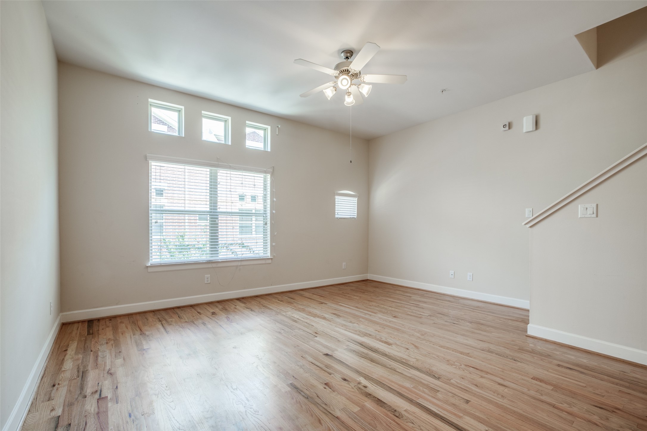 2710 Hullsmith Drive, Unit 401 Houston, TX 77063 - Photo 12 of 25 a view of an empty room with wooden floor and a window