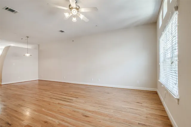 wooden floor in an empty room with a window