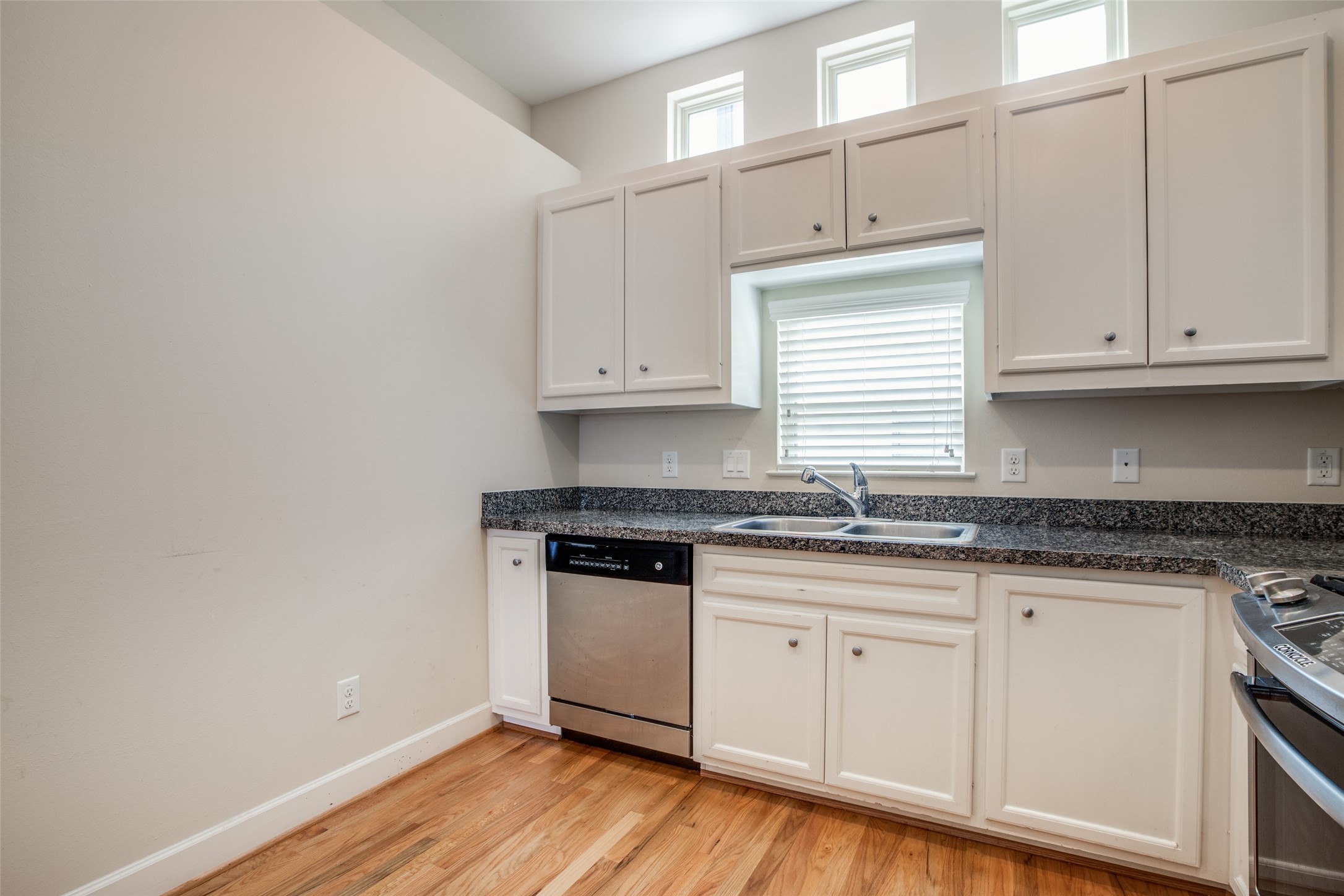 2710 Hullsmith Drive, Unit 401 Houston, TX 77063 - Photo 19 of 25 a kitchen with granite countertop wooden cabinets and a sink