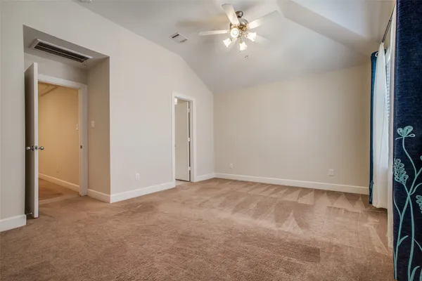 a view of an empty room with a fan