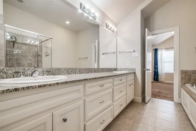 a bathroom with a granite countertop sink mirror and double