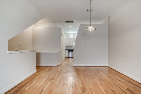 a view of a room with wooden floor and white walls