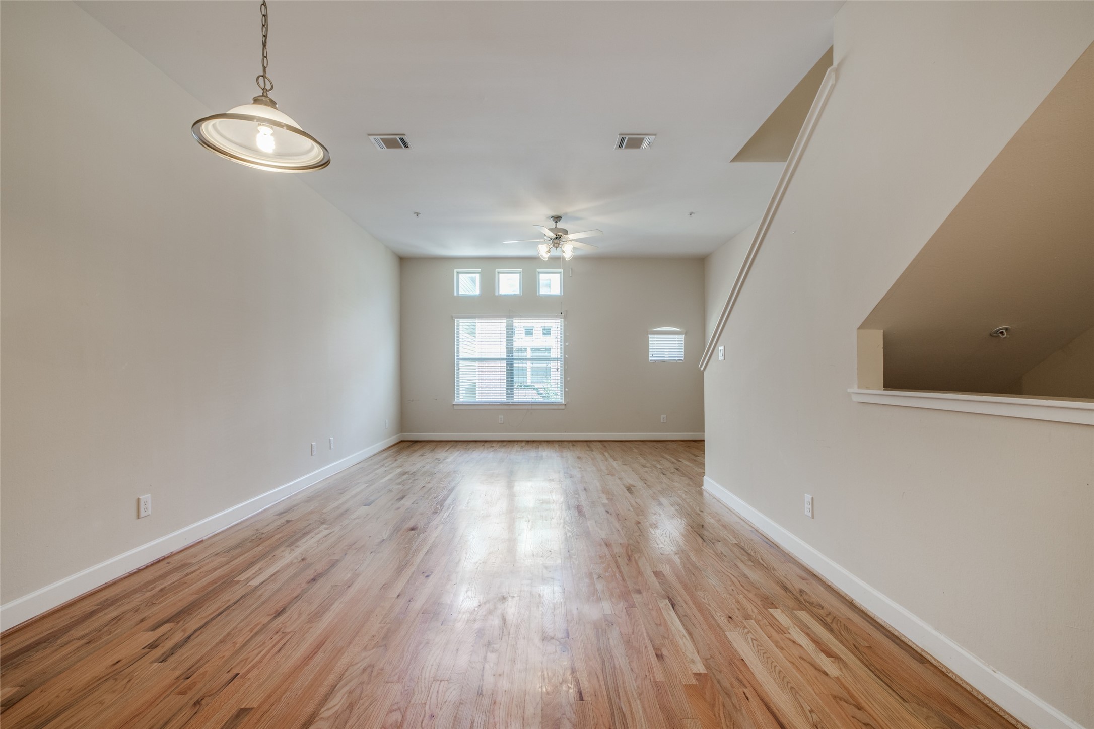 2710 Hullsmith Drive, Unit 401 Houston, TX 77063 - Photo 8 of 25 an empty room with wooden floor and windows