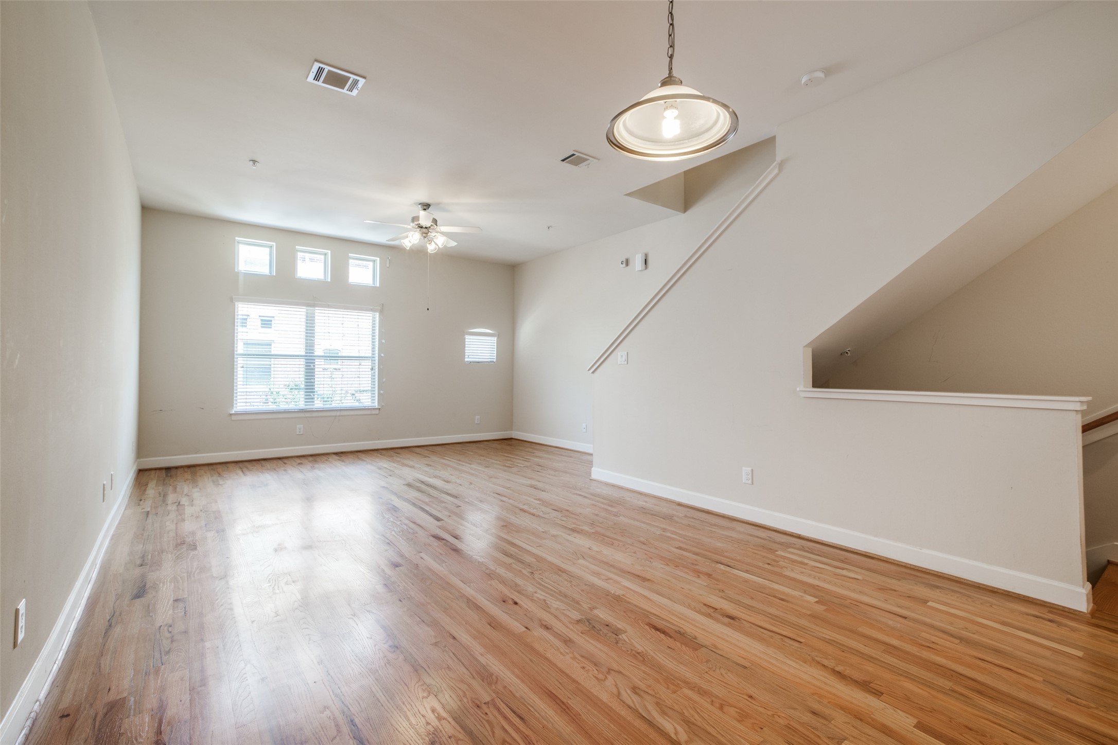 2710 Hullsmith Drive, Unit 401 Houston, TX 77063 - Photo 9 of 25 an empty room with wooden floor and windows