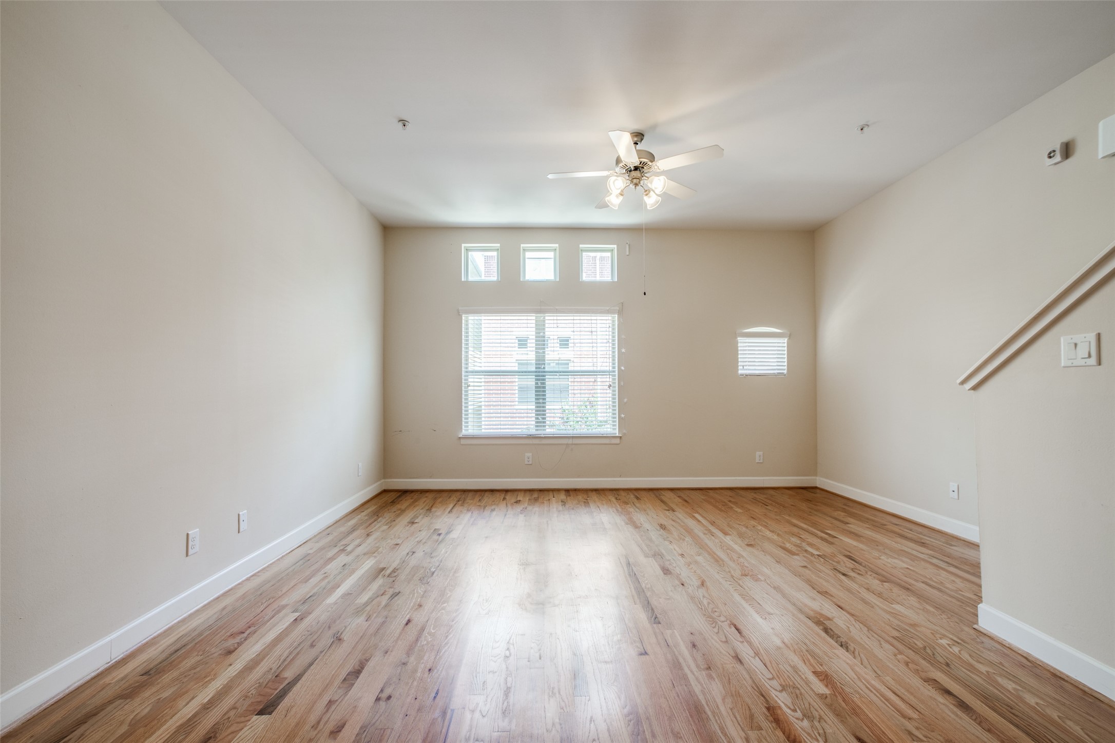 2710 Hullsmith Drive, Unit 401 Houston, TX 77063 - Photo 10 of 25 a view of an empty room with wooden floor and a window