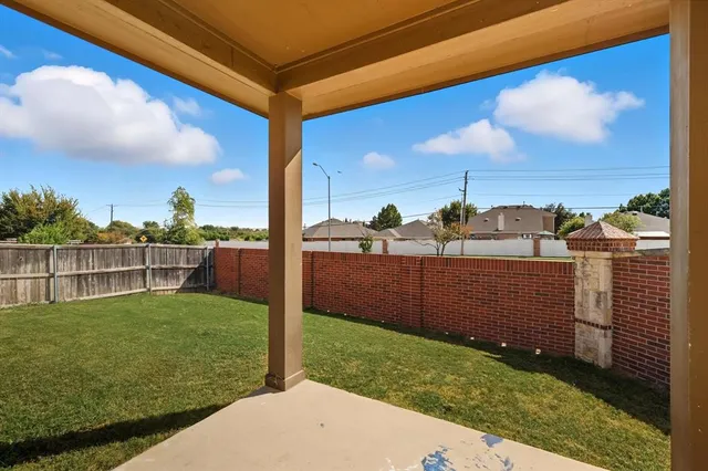a view of a backyard with sitting area
