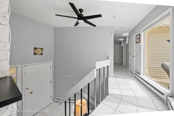 a view of a hallway with wooden floor and staircase
