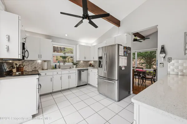a kitchen with granite countertop a refrigerator and a sink