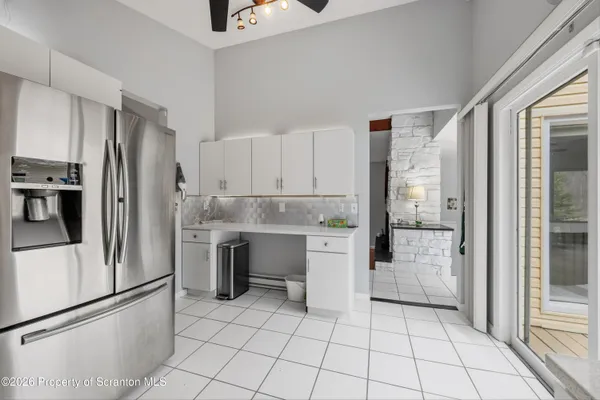 a kitchen with granite countertop a refrigerator and a stove top oven