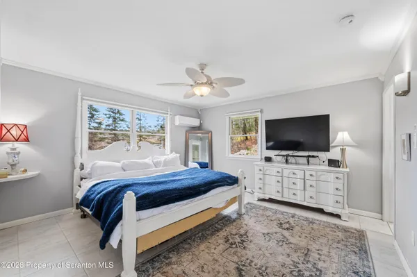 a bedroom with a bed a television and dresser
