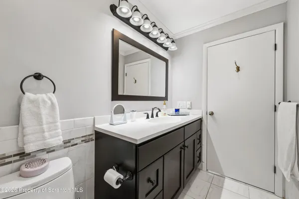a bathroom with a sink a toilet and mirror