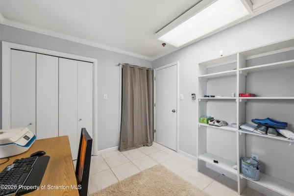 a room with a chair and white walls