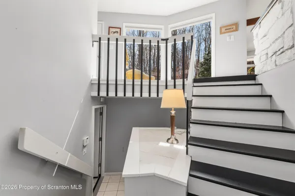 a view of entryway with wooden floor and stairs