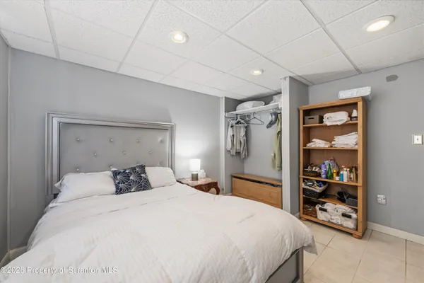 a bedroom with a large bed and a walk in closet