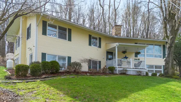 a view of house with backyard
