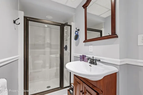 a bathroom with a sink a mirror and a shower