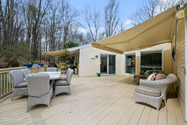 a view of a patio with couches and table and chairs next to yard