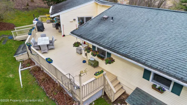 a roof deck with table and chairs