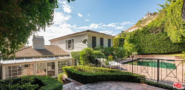 a front view of a house with a garden