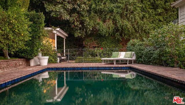 a view of house with swimming pool outdoor seating
