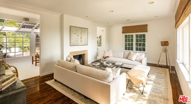 a living room with furniture a fireplace and a table