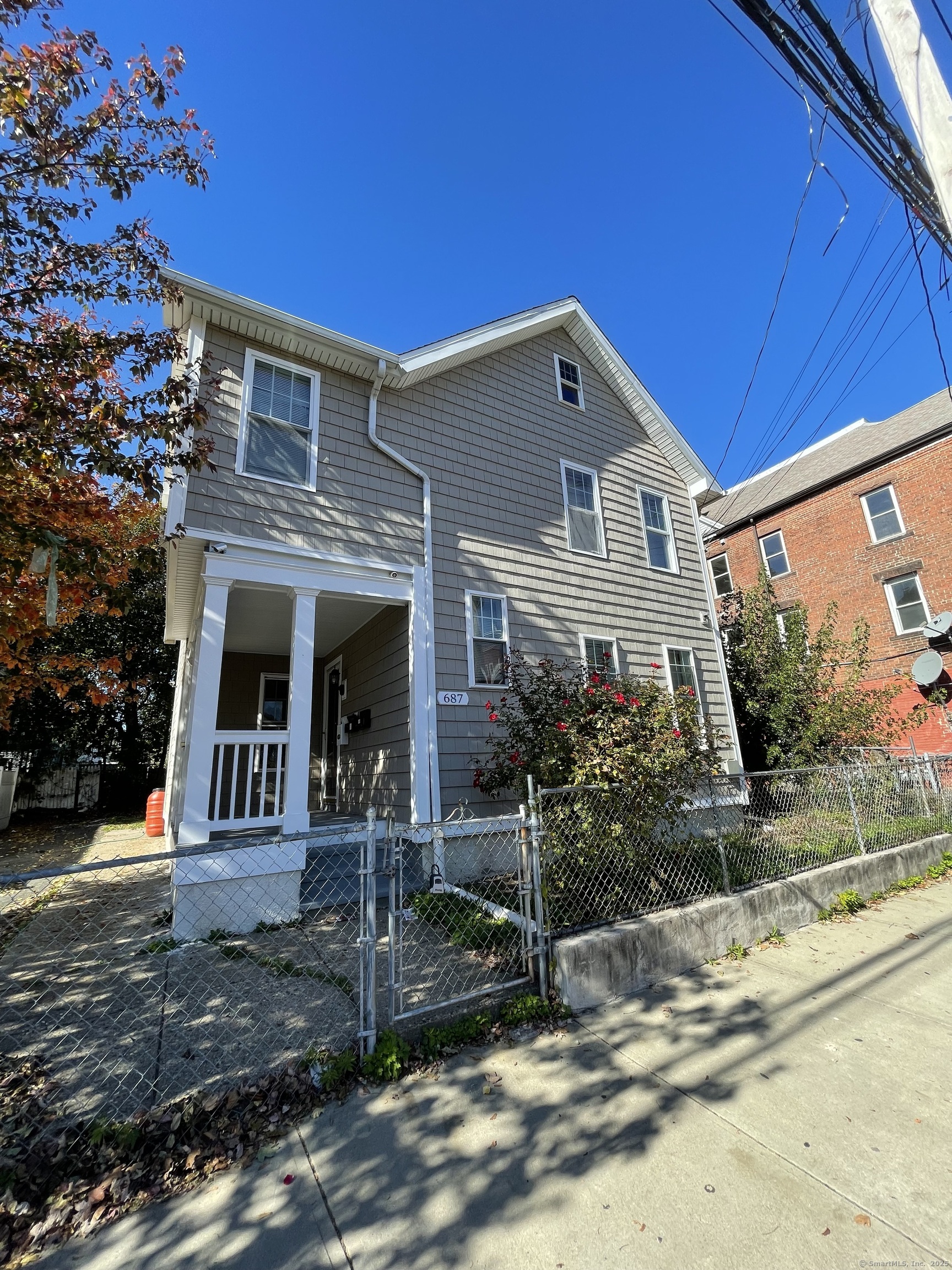 687 Hallett Street Bridgeport, CT 06608 - Photo 1 of 5 a front view of a house with garden