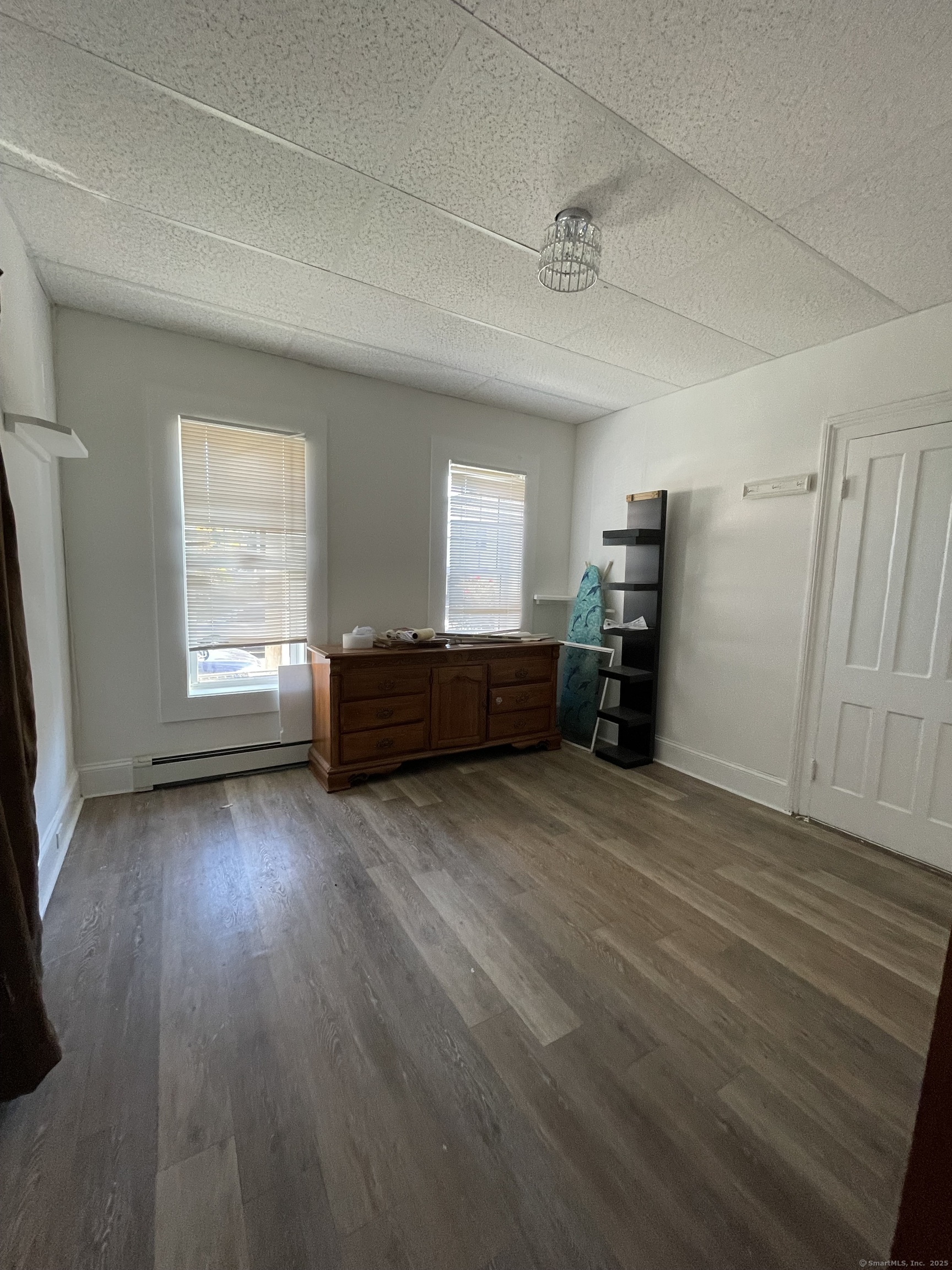 687 Hallett Street Bridgeport, CT 06608 - Photo 3 of 5 a view of empty room with a fireplace and wooden floor
