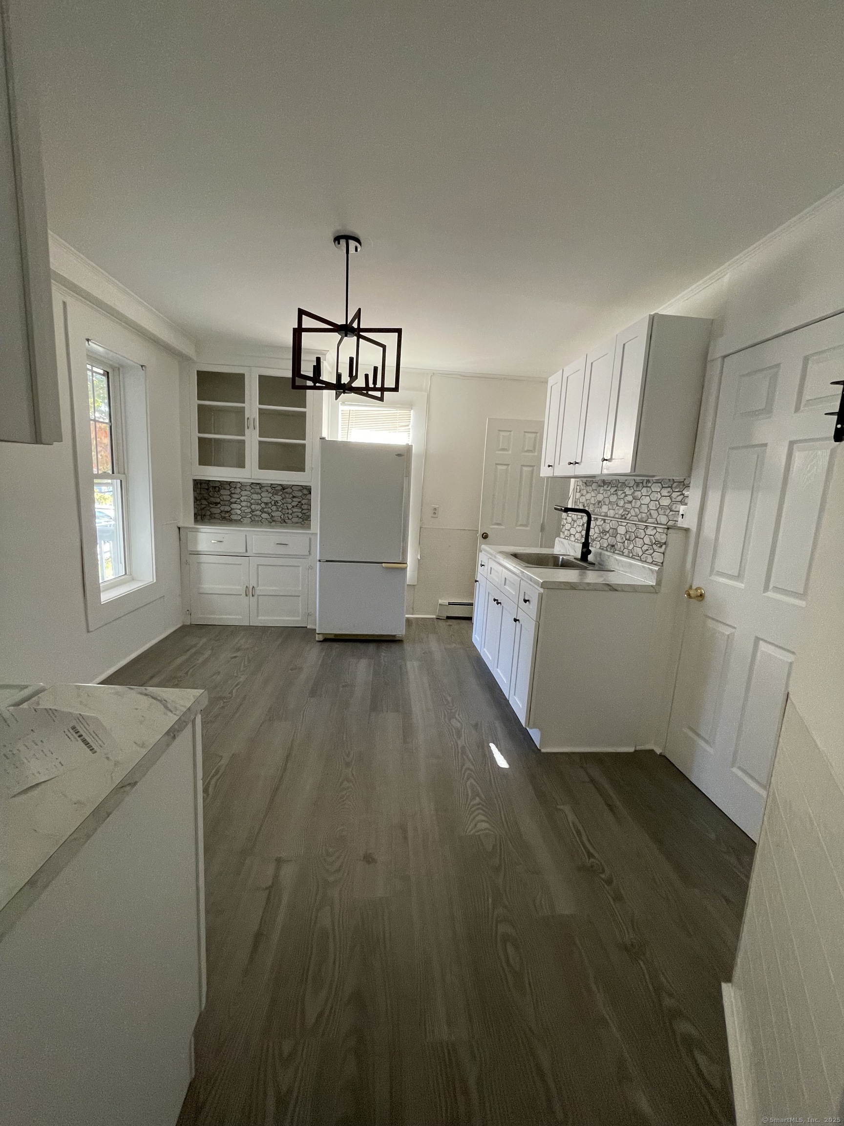 687 Hallett Street Bridgeport, CT 06608 - Photo 5 of 5 a kitchen with stainless steel appliances a refrigerator sink and cabinets