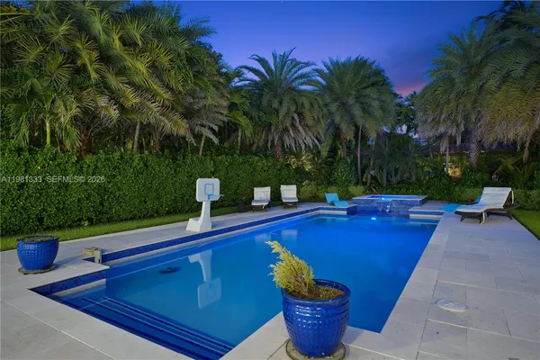 a view of a house with a yard and a fountain
