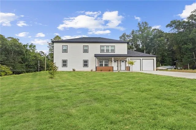 a view of a house with a yard