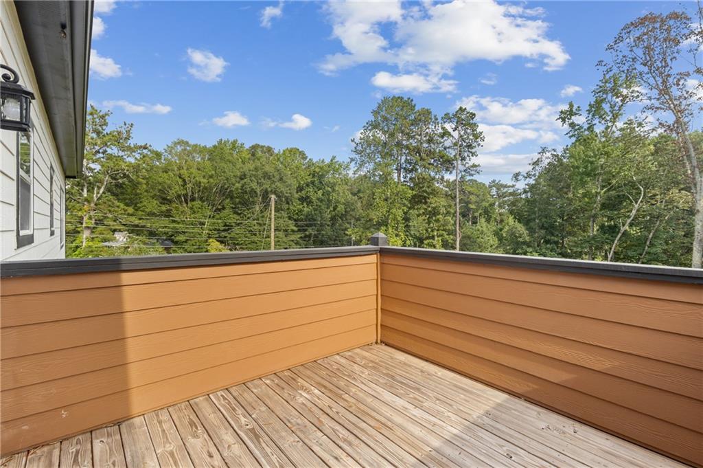 1275 Riverside Road Sugar Hill, GA 30518 - Photo 13 of 17 a view of balcony with wooden floor and fence