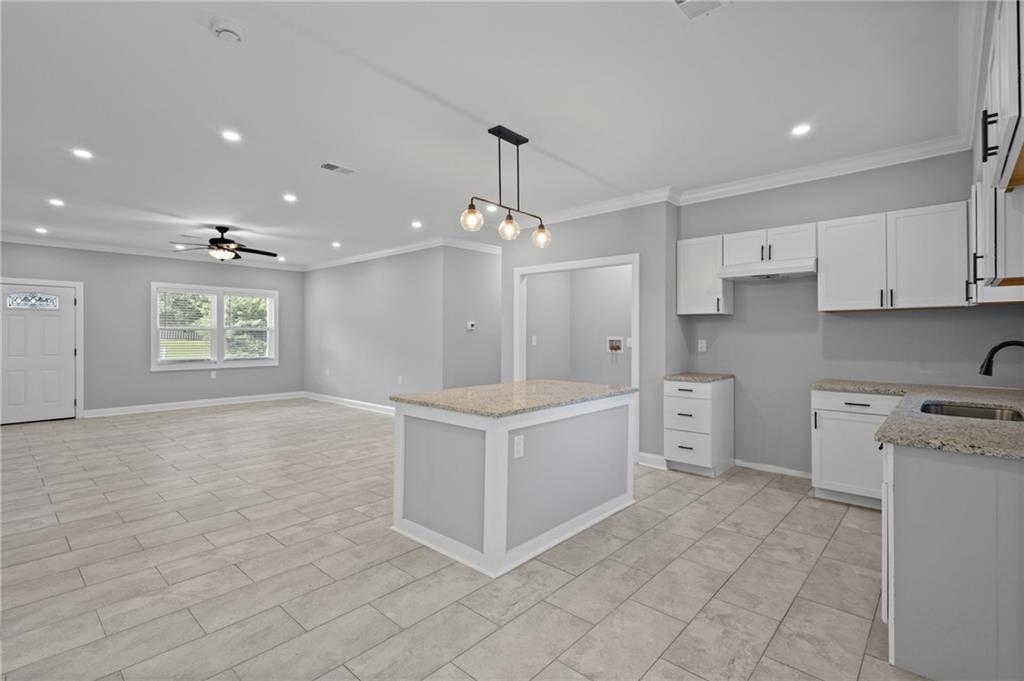 1275 Riverside Road Sugar Hill, GA 30518 - Photo 2 of 17 a large white kitchen with cabinets