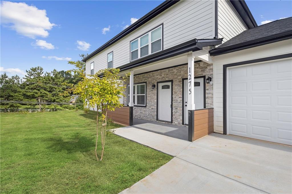 1275 Riverside Road Sugar Hill, GA 30518 - Photo 7 of 17 a front view of a house with a garden