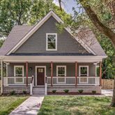 a view of house with a yard