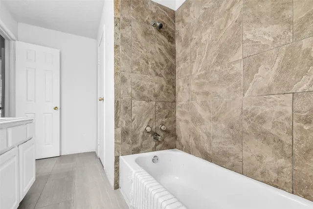 a bathroom with a bathtub and shower