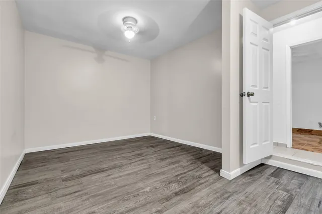 a view of an empty room with wooden floor