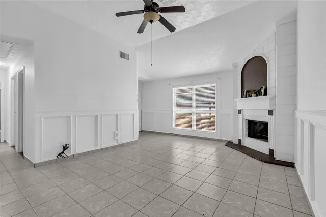 a view of livingroom with furniture fireplace and window