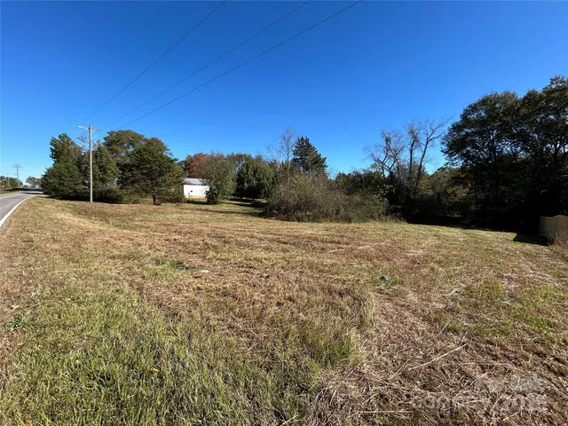 a view of dirt field with trees