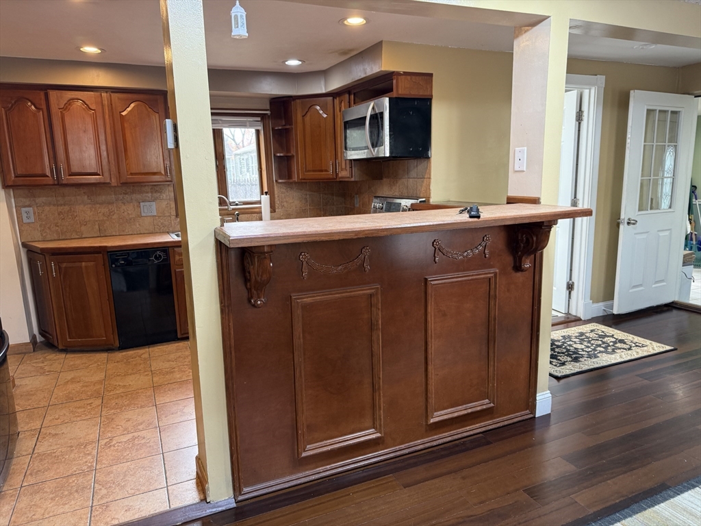 63 Peer Street Springfield, MA 01109 - Photo 11 of 41 a kitchen with stainless steel appliances granite countertop a sink and a stove