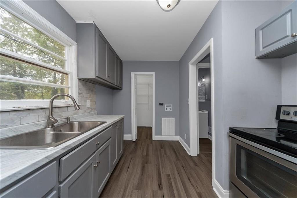 4161 Tell Road Southwest, Unit B Atlanta, GA 30331 - Photo 12 of 16 a kitchen with a sink and wooden floor