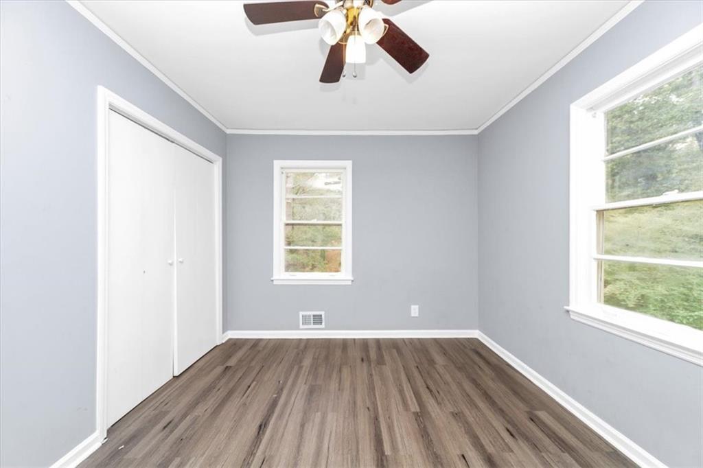 4161 Tell Road Southwest, Unit B Atlanta, GA 30331 - Photo 13 of 16 a view of an empty room with wooden floor and a window