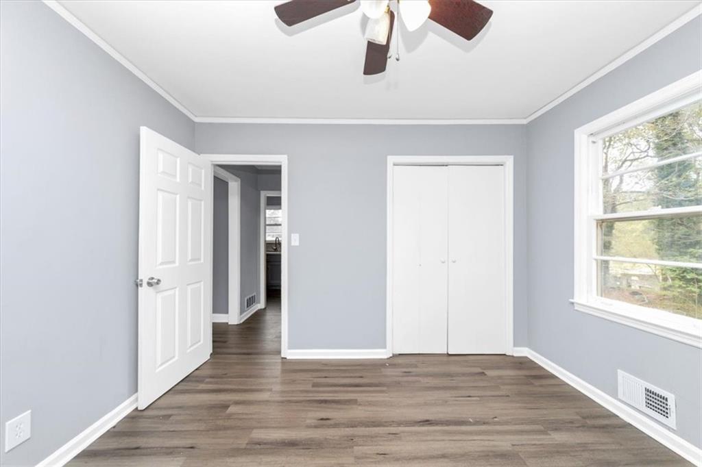 4161 Tell Road Southwest, Unit B Atlanta, GA 30331 - Photo 14 of 16 a view of an empty room with wooden floor and a window