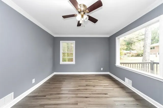 wooden floor in an empty room with a window