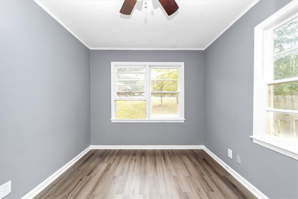 4161 Tell Road Southwest, Unit B Atlanta, GA 30331 - Photo 6 of 16 a view of an empty room with wooden floor and a window