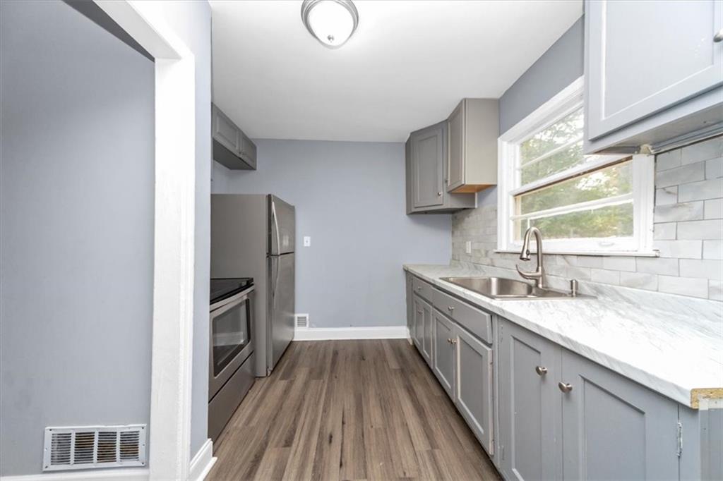 4161 Tell Road Southwest, Unit B Atlanta, GA 30331 - Photo 9 of 16 a kitchen with granite countertop a sink stove and refrigerator